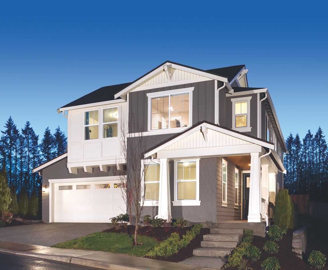 Exterior of a Pacific Northwest craftsman style house that's comprised of a mix of materials and a grey and white color scheme.