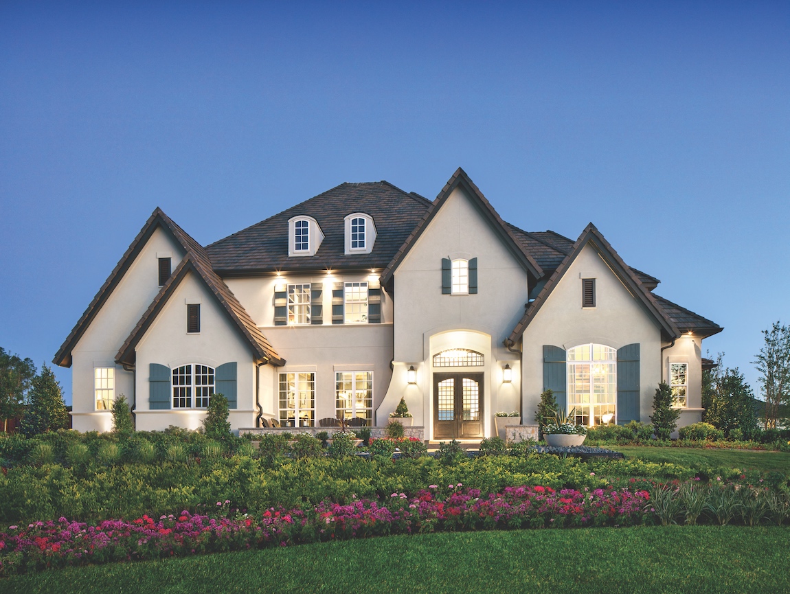 A home in Texas with a lit up front door.