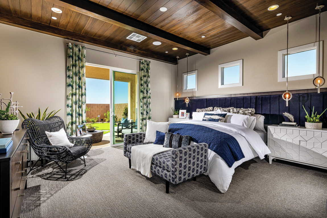 A contemporary bedroom with blue accents and comfortable furniture.