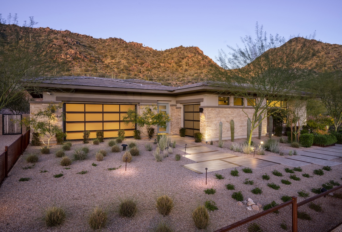 A Toll Brothers house in Arizona with lights in the front yard.