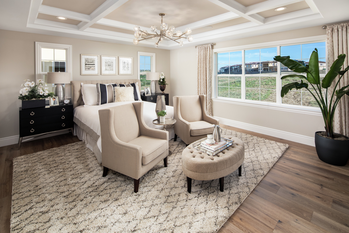 A luxury bedroom with beige walls and beige furniture.