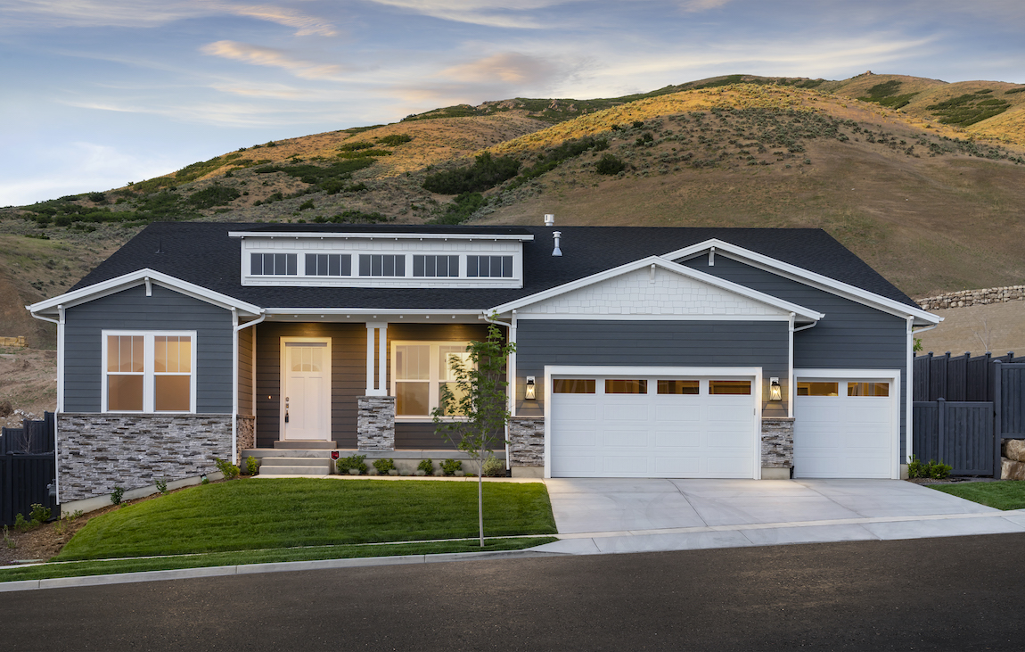 Exterior of a craftsman style house in Utah with mountains in the background.