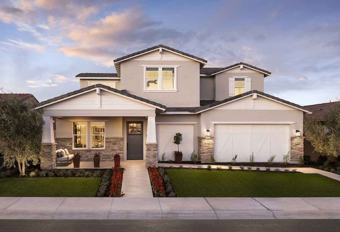 A Toll Brothers craftsman style home with low pitched roofs and a muted earth tones.