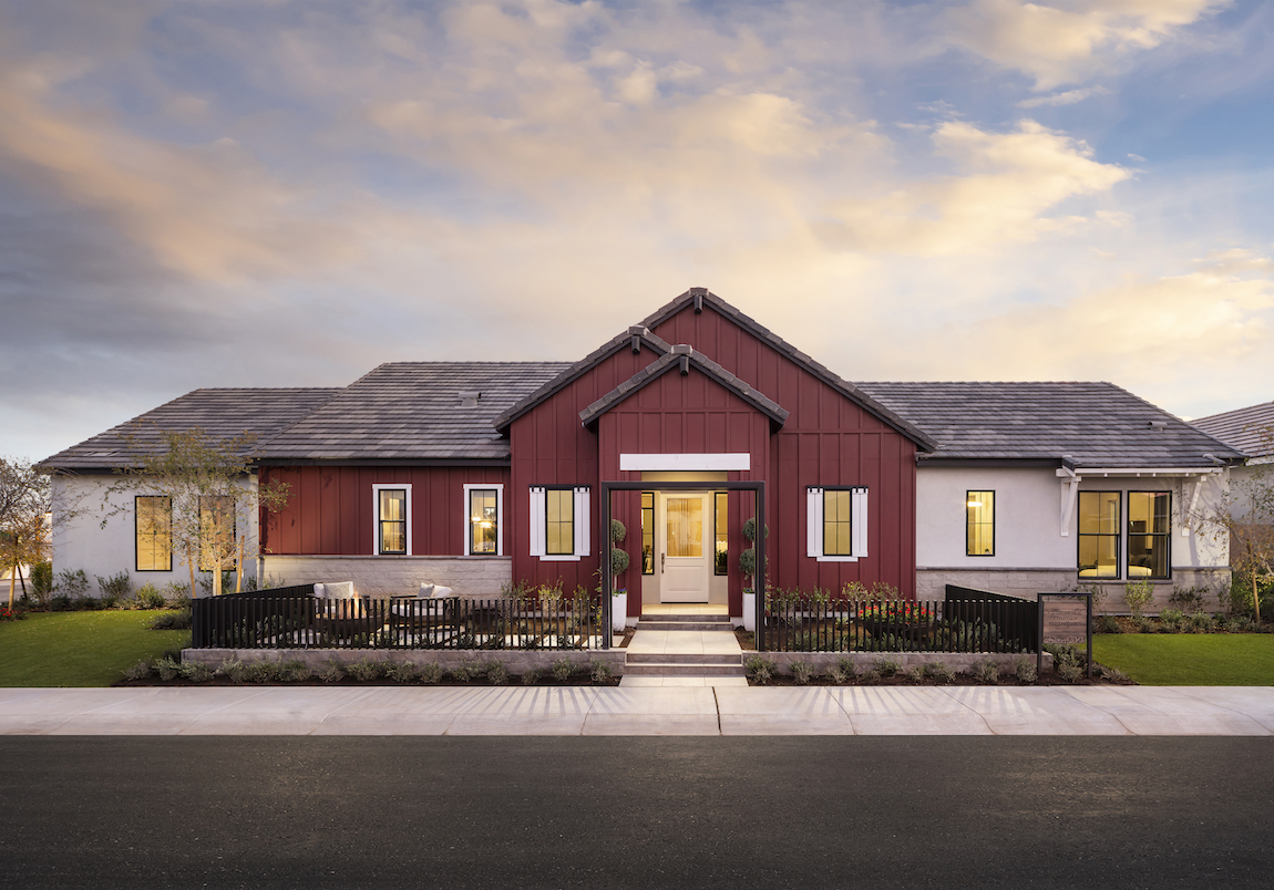 Modern farmhouse with a dark red home exterior color.
