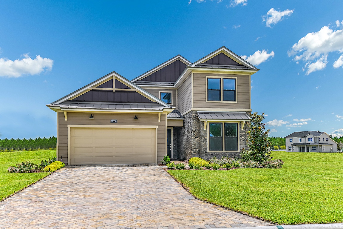 A modern craftsman style home with a beige and earthy exterior color.