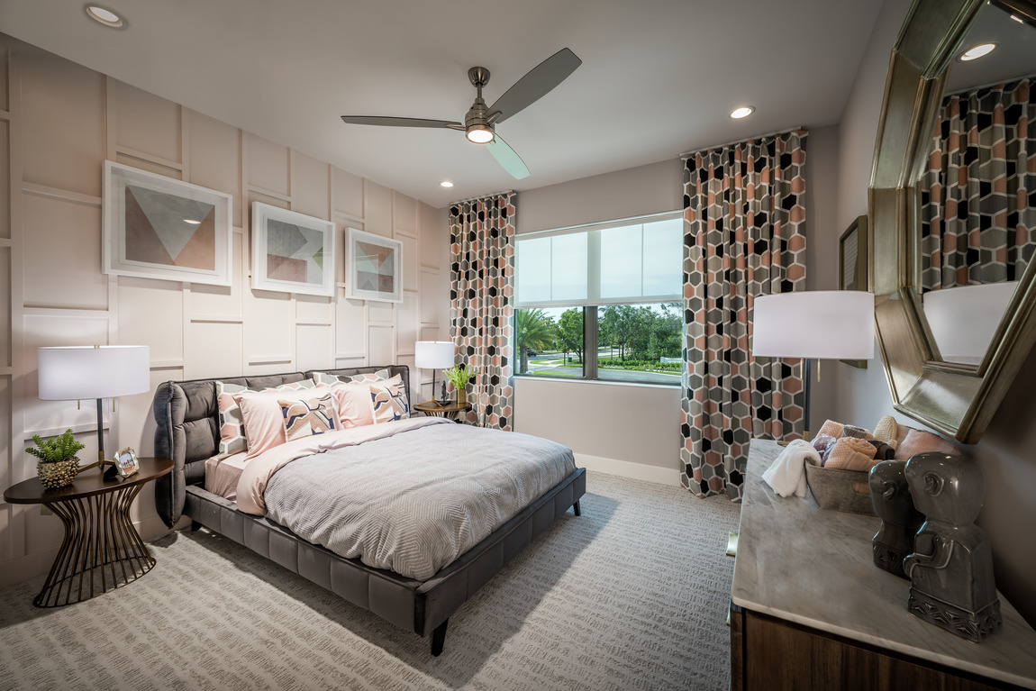 A bedroom with prominently patterned curtains.