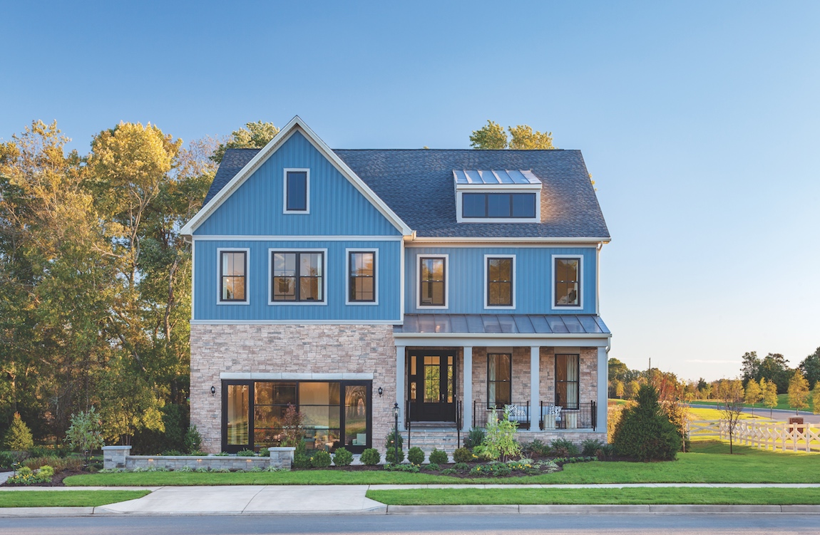 A modern farmhouse home with a blue exterior color.