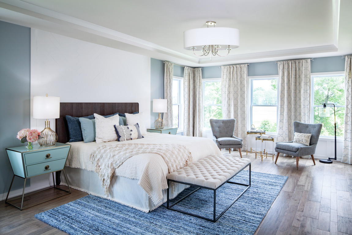 Bedroom with a blue rug and blue paint.