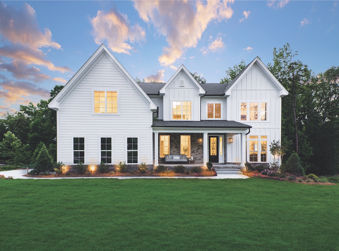 An all-white modern farmhouse exterior.