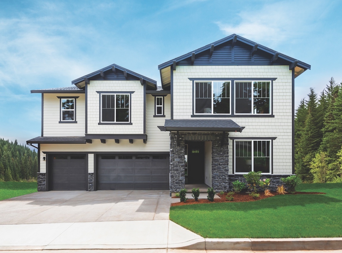 Exterior of a light colored craftsman house with dark trim.