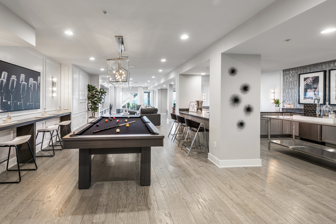 Luxe basement design with ample features such as pool table, home bar, and entertainment area