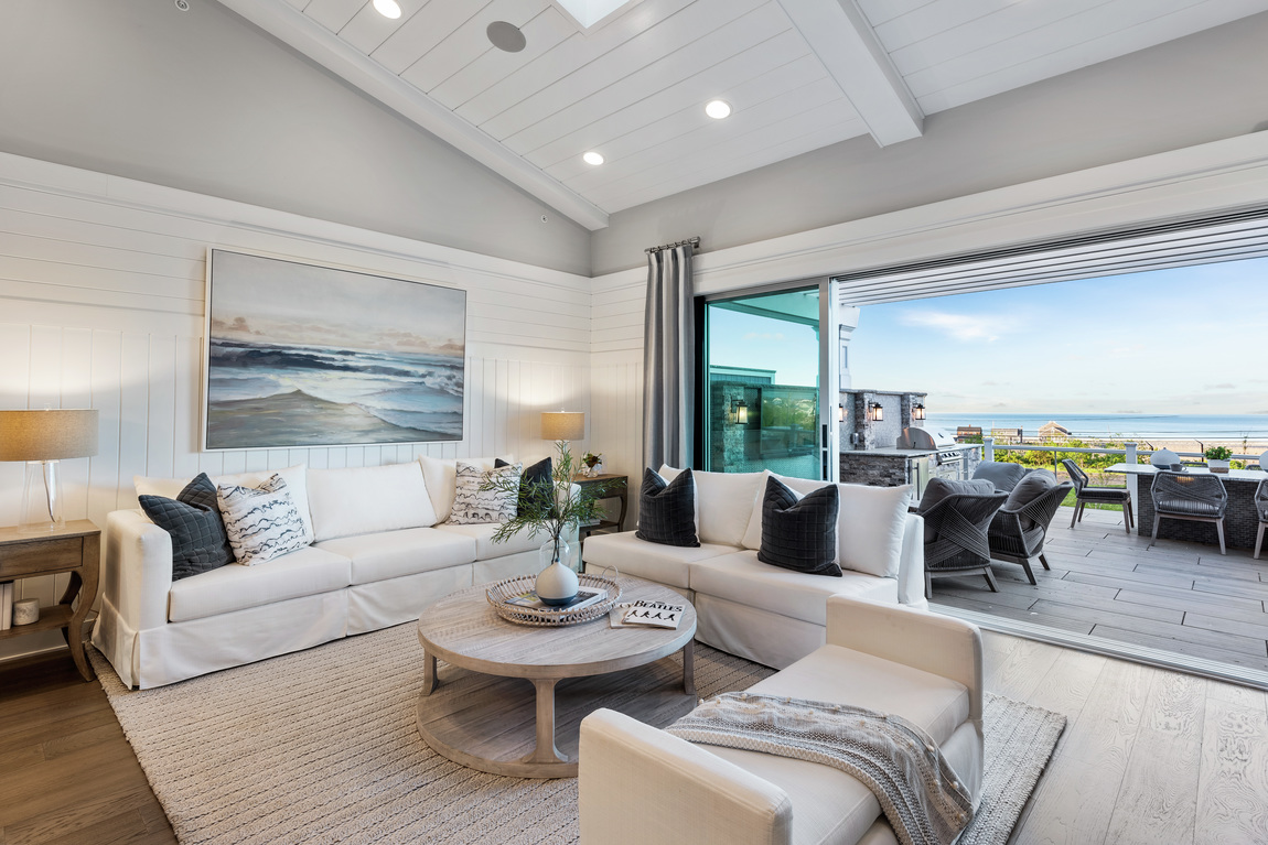 Living room with coastal artwork that plays into home's overall ambiance