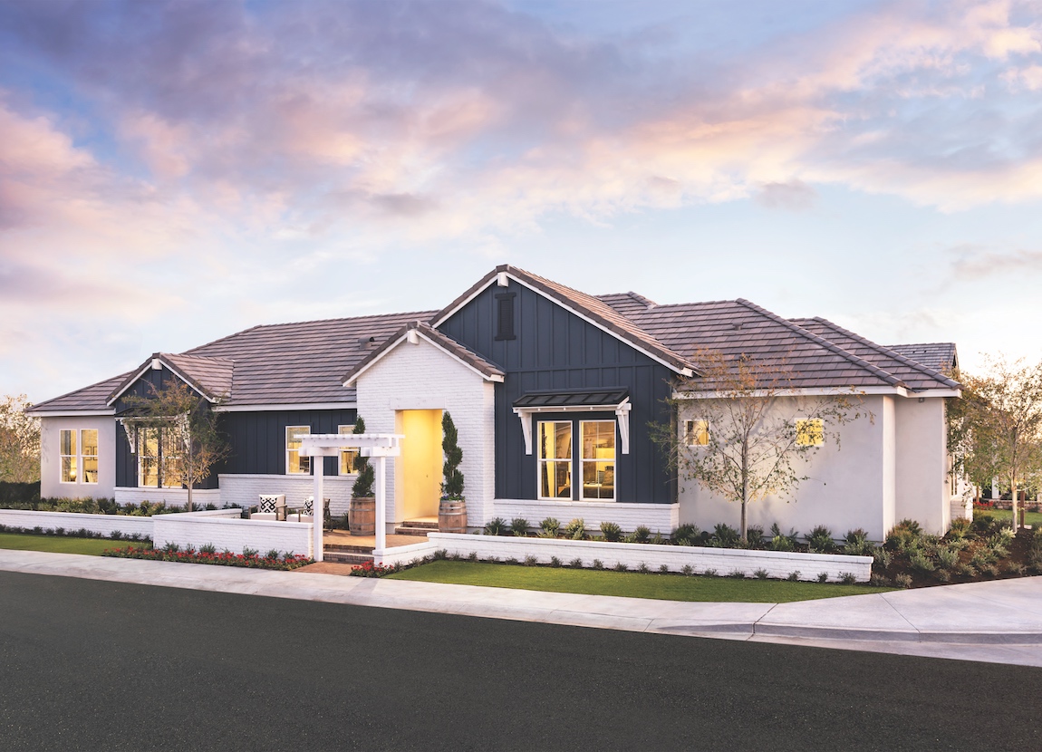 A modern farmhouse with a blue and white exterior color combination.