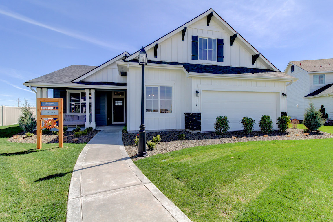 Single family home with a white exterior and contrasting gable brackets.