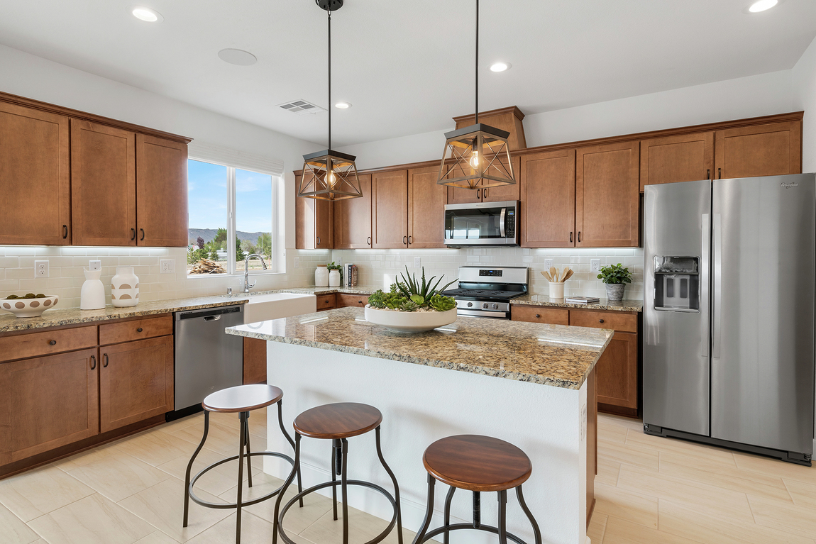 Luxe kitchen with elegant pendant lighting and granite countertop island