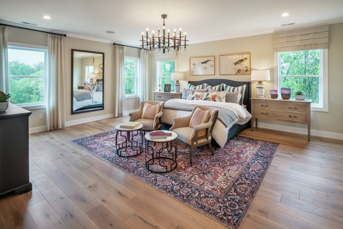 A classically designed bedroom with an elegant rug.
