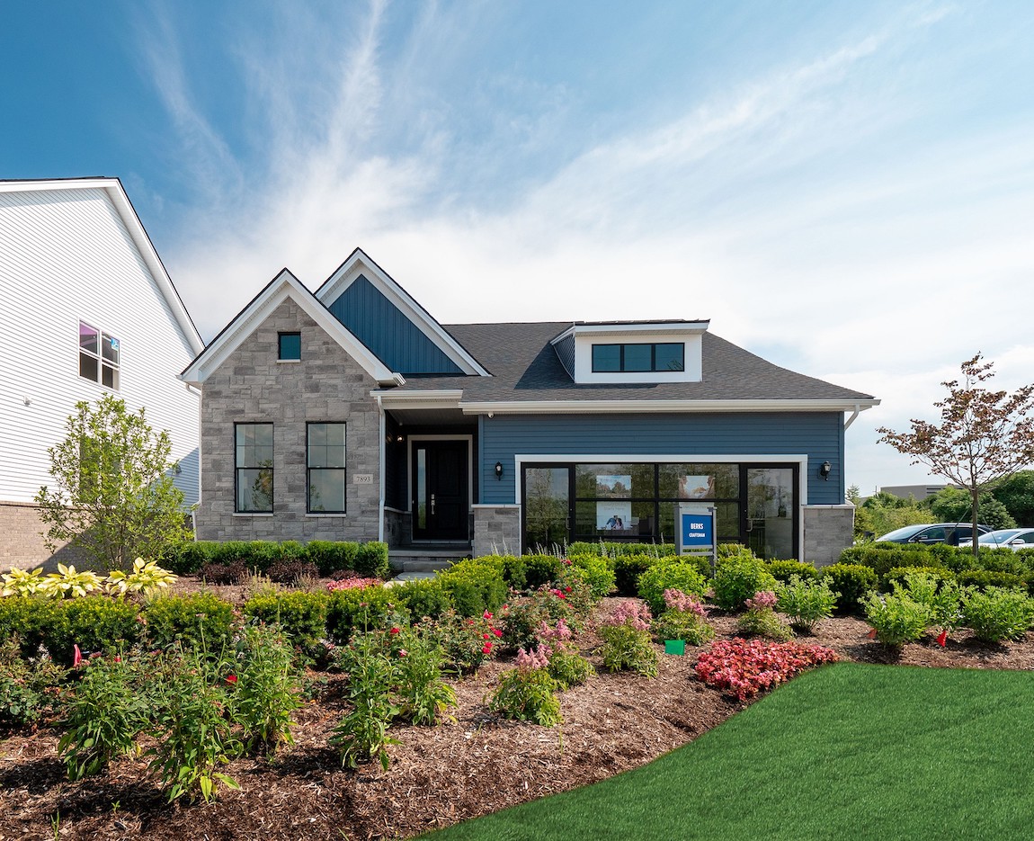 A modern home with blue siding and black window trim.