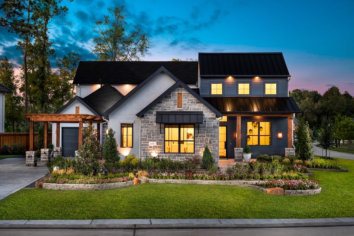 A modern farmhouse home in Texas with various exterior lighting.