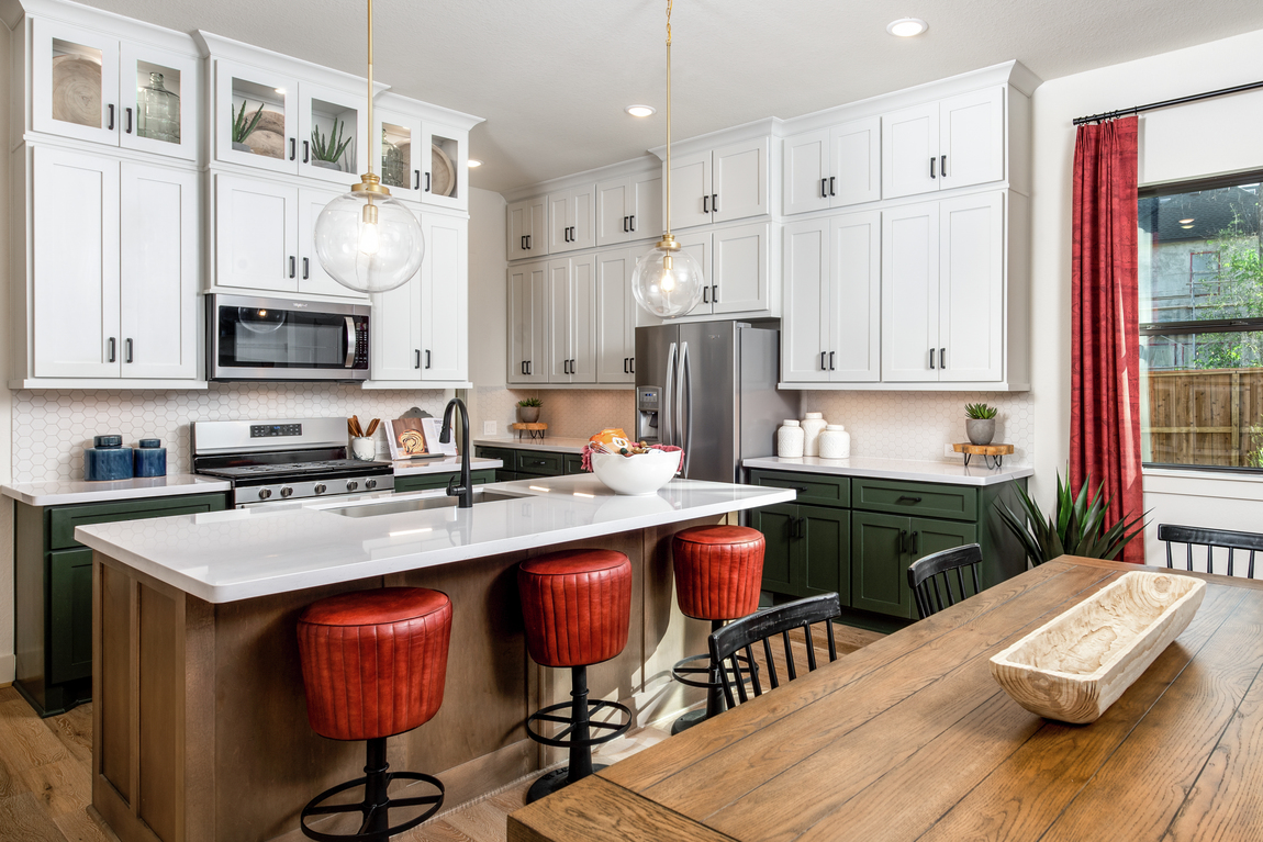 Kitchen featuring cherry-red barstools and a wooden kitchen island.