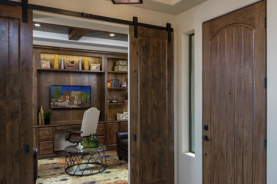 Barn door in a home office that matches the home's front door.