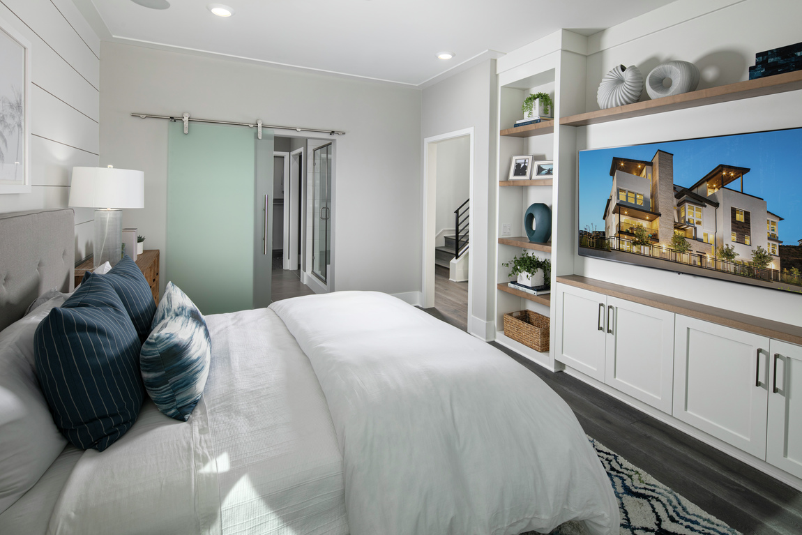 A bedroom with a frosted glass barn door.