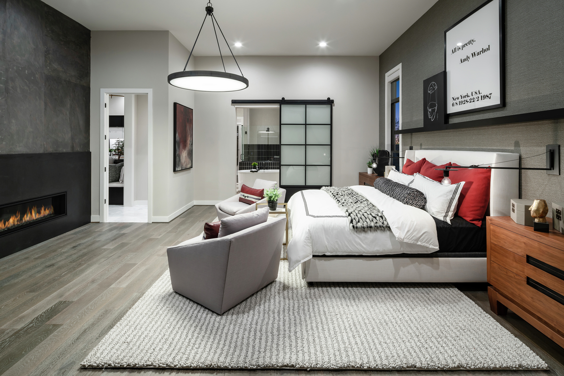 A dark metal frame barn door in a modern luxury bedroom.