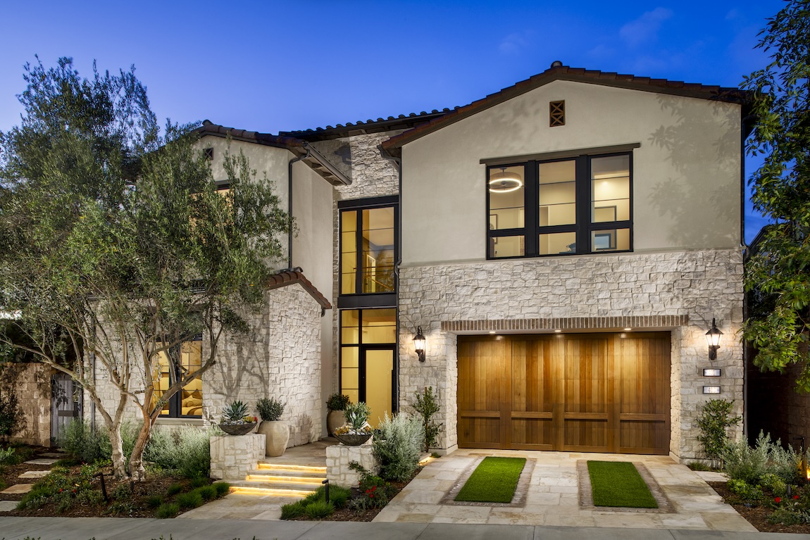 exterior of home with lighting on the driveway