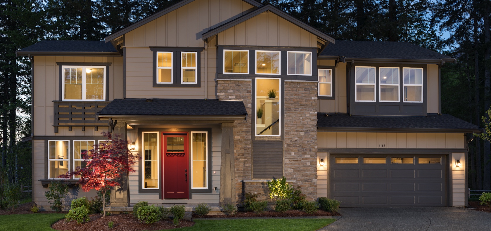 Suburban new construction home with a red front door.