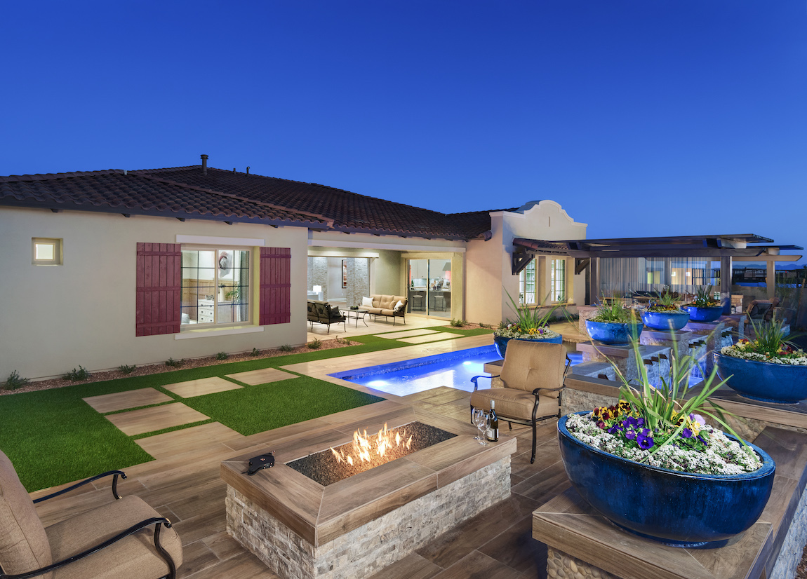 Luxury backyard with a pool, a built-in fire pit and sitting area.
