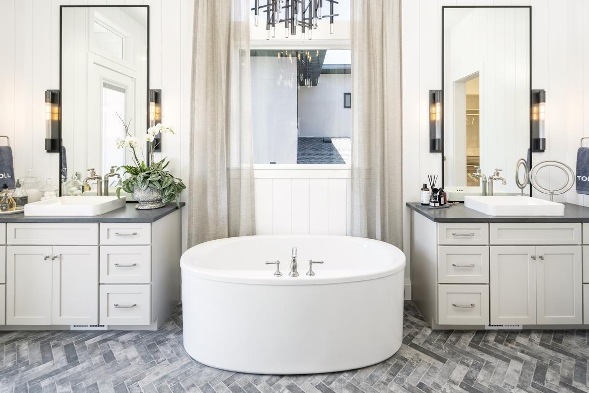 dual bathroom with modern white tub