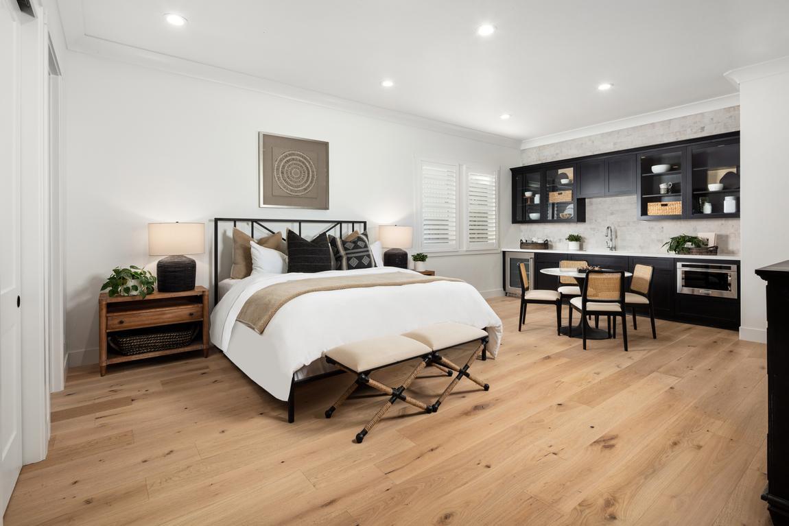 Primary bedroom suite with seating and storage area