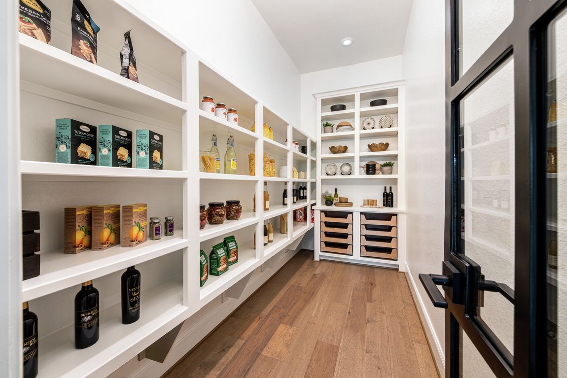 Modern walk-in [pantry with ample cabinet space for food storage