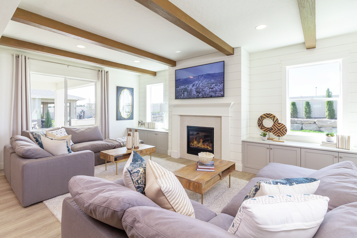 A traditional fireplace place and mantle surrounding by white shiplap.