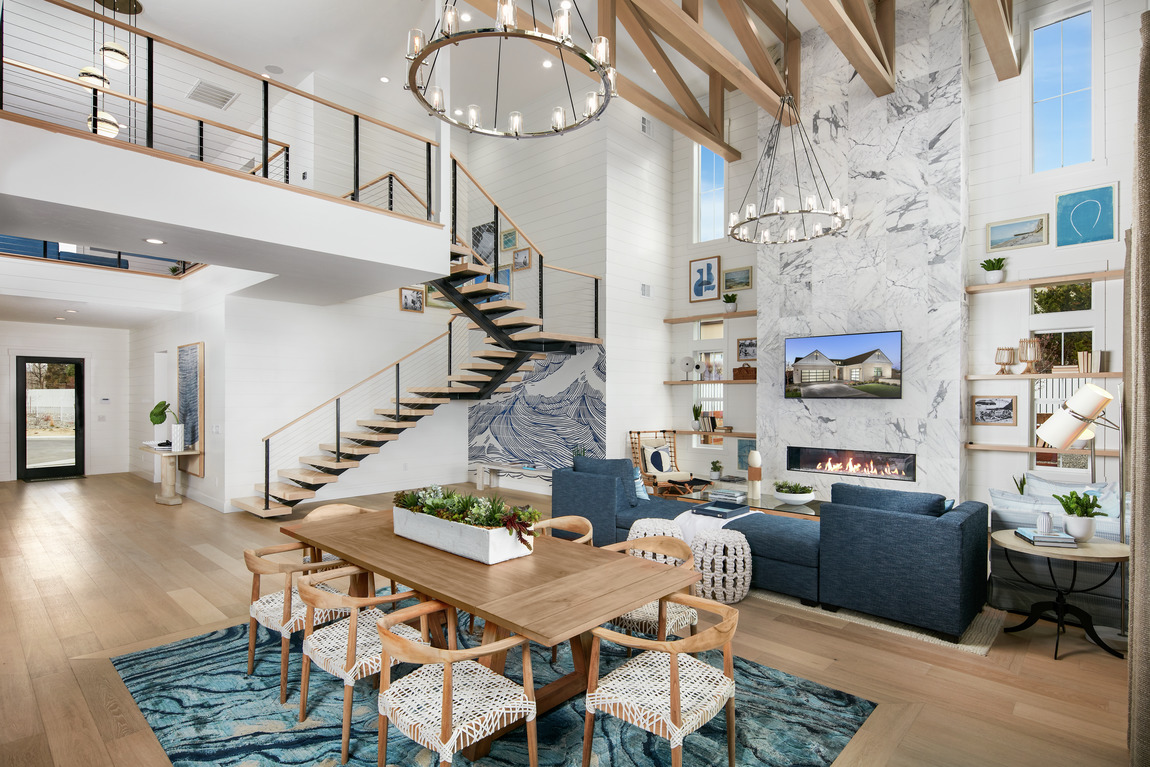 Two-story great room featuring chandelier