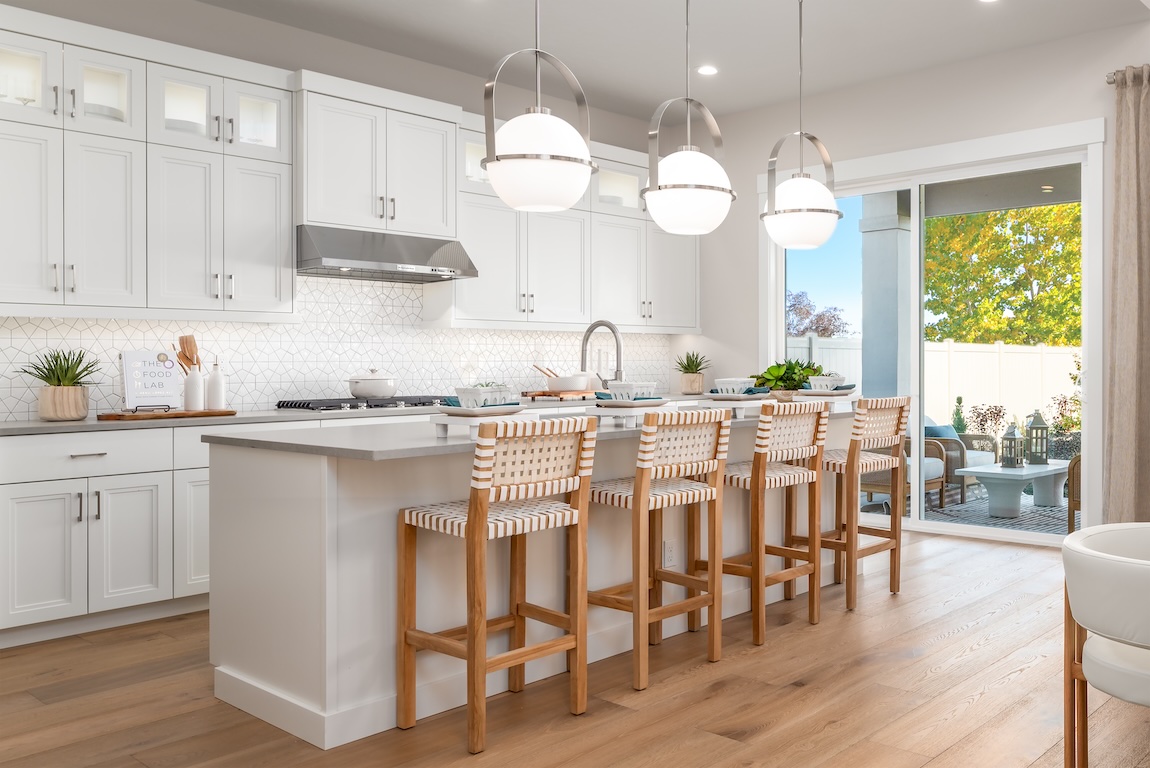 modern kitchen with wooden seats and pendant lights