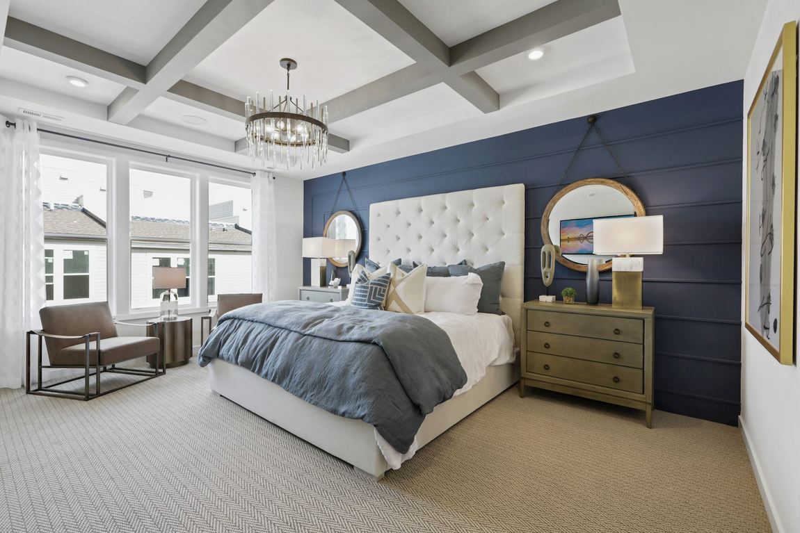 Modern bedroom with beam ceiling and blue accent wall