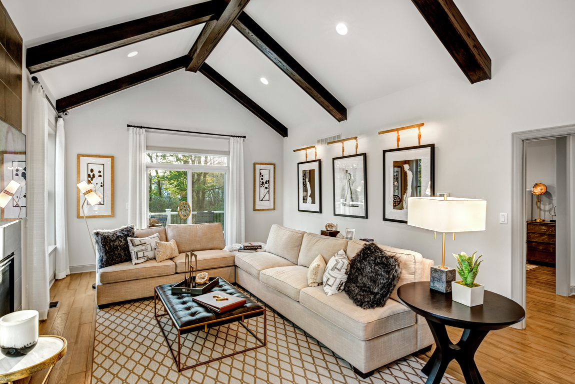 A farmhouse style great room with a vaulted ceiling