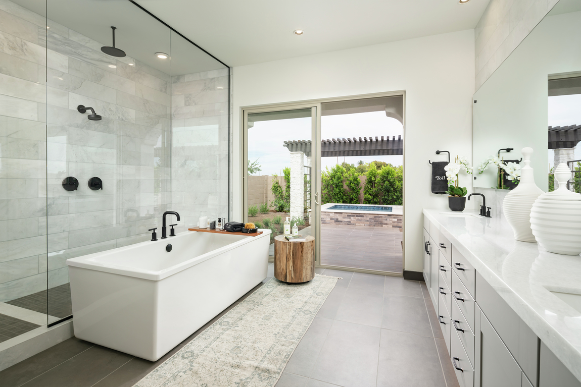 Bathroom with a sliding door that opens to an outdoor patio. 