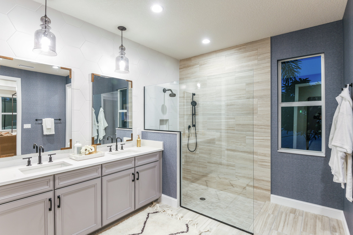 Primary bathroom with blue walls and a large and open walk-in shower.