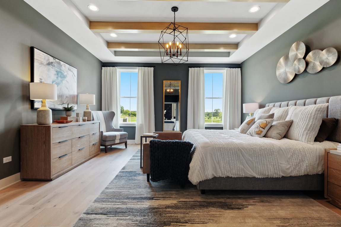 bedroom with tray beam ceiling