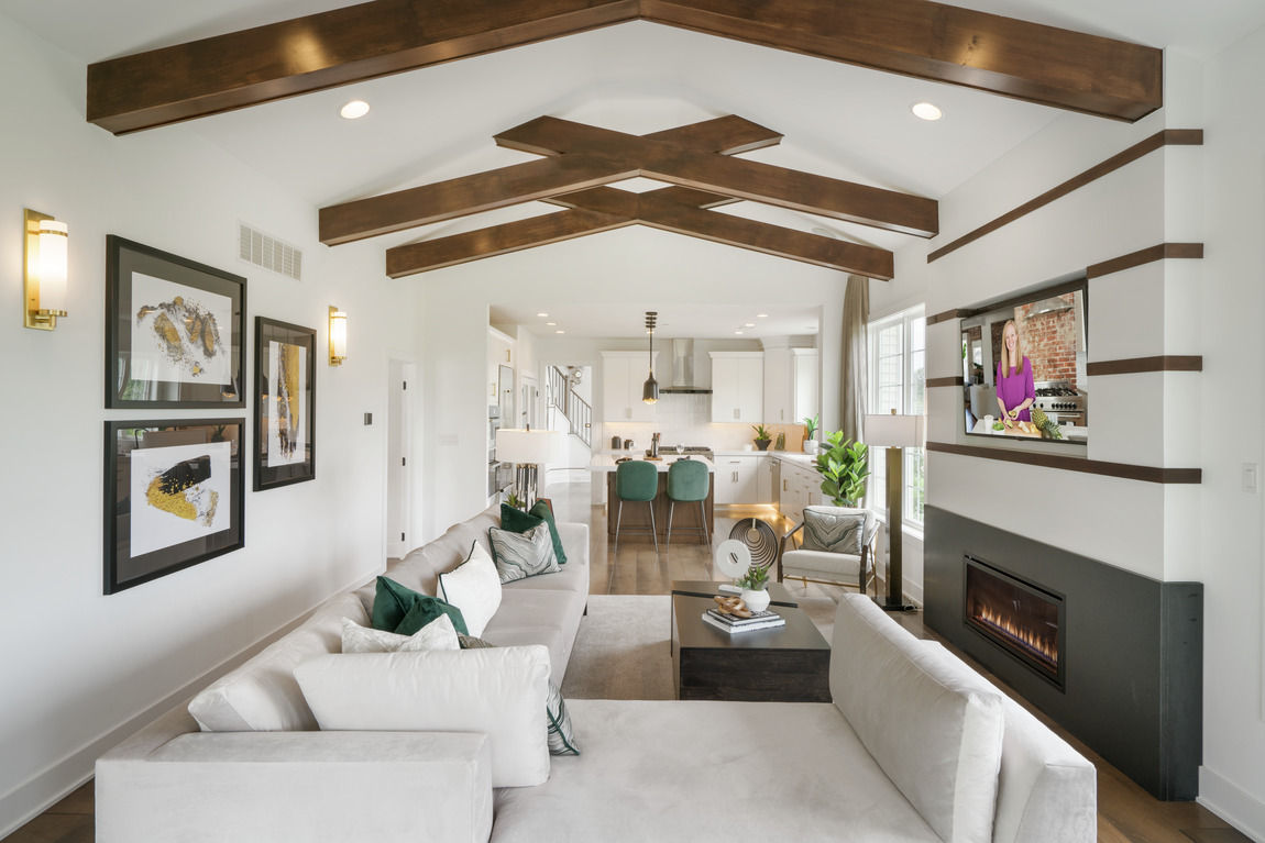 great room accented by vaulted wood beam ceiling