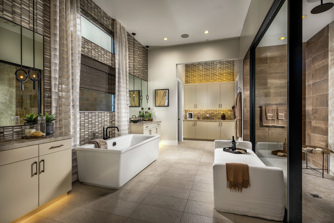 luxury bathroom with sleek tile and accent lighting