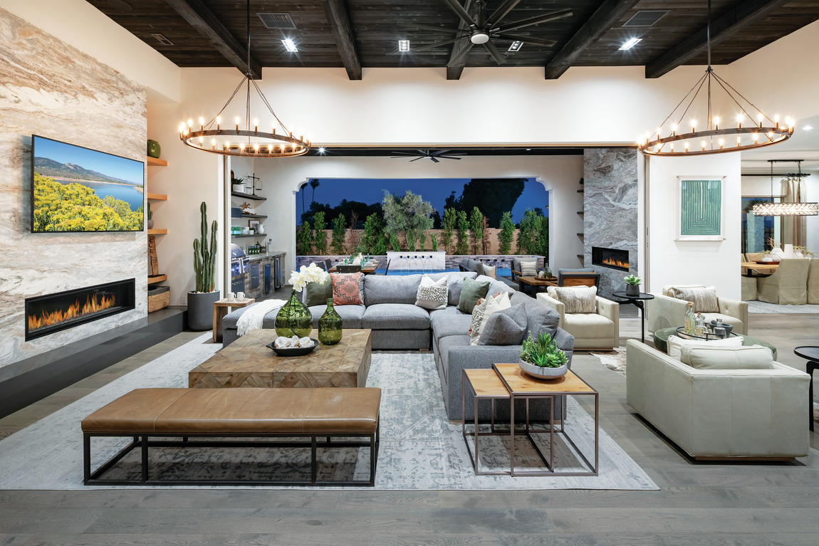 spacious great room with elevated black wood beam ceilings