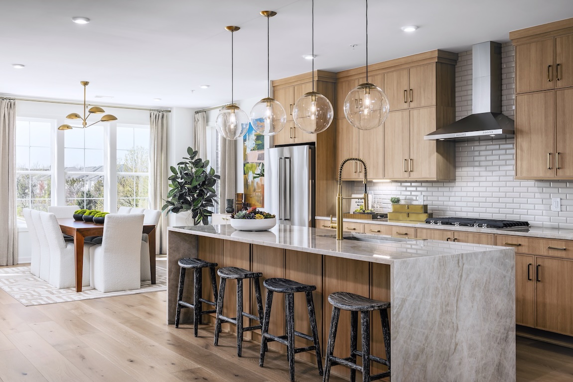 modern kitchen with globe pendant lights and waterfall island