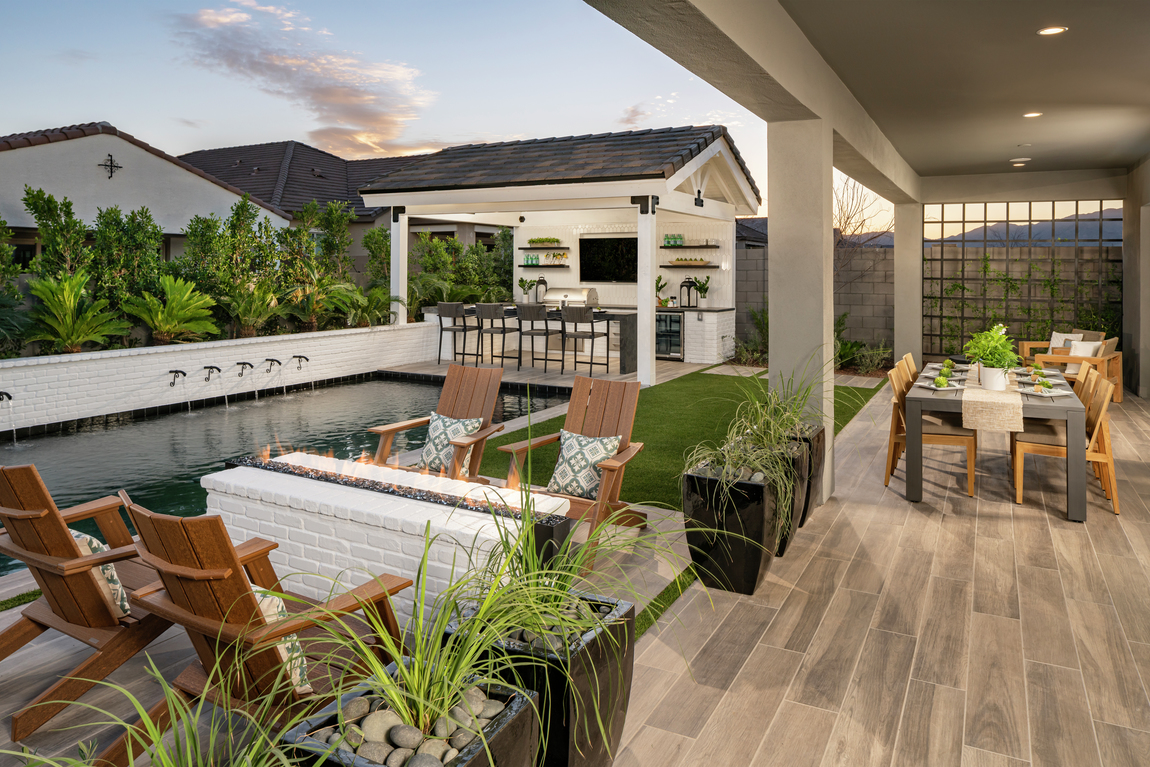 Luxurious backyard with fire pit, pool, and outdoor kitchen for holiday gatherings