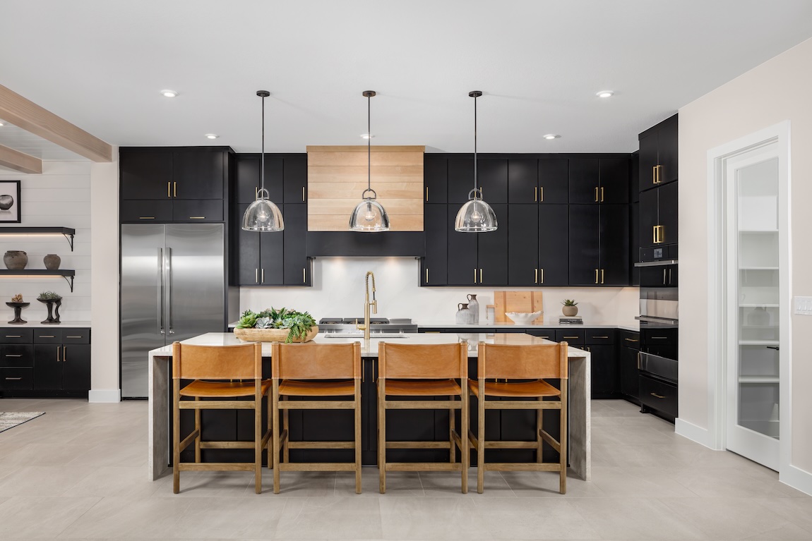 modern kitchen with black cabinetry and a waterfall island
