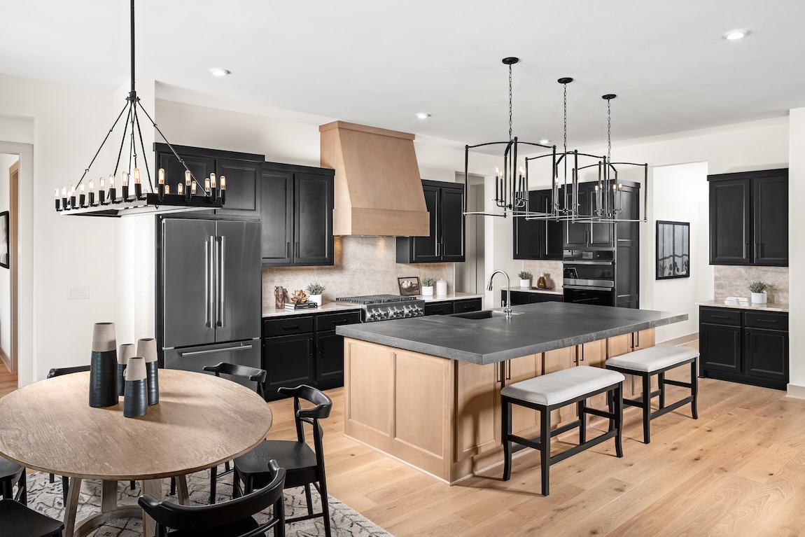 modern farmhouse kitchen with black cabinetry and wooden accents