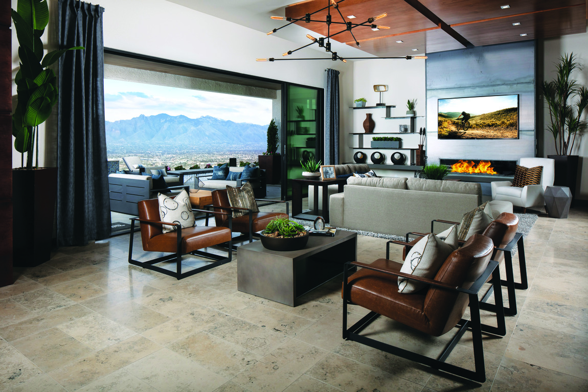Indoor to outdoor living great room with dark wood finishes, fireplace and view of the mountains