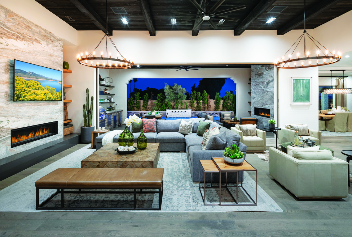 Great living room with open floor plan, circular lighting fixtures, black wooden beam ceiling and indoor to outdoor living entry