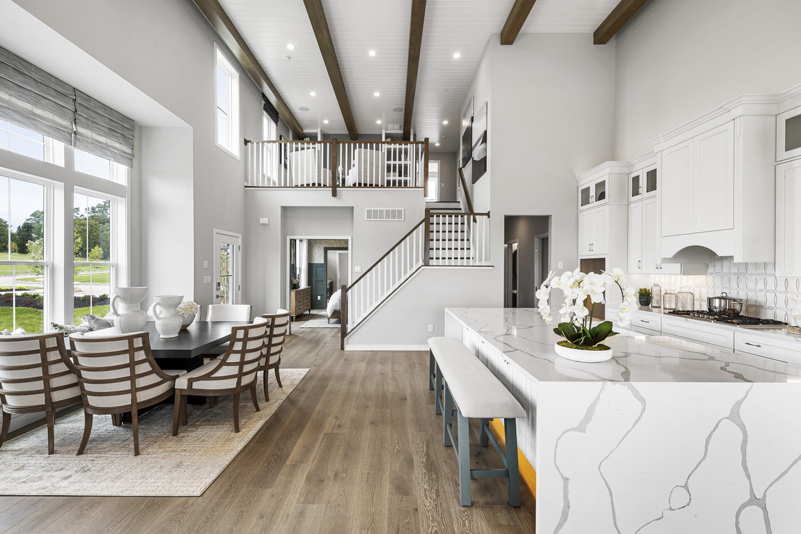 Great room with white quartz kitchen island and dining table